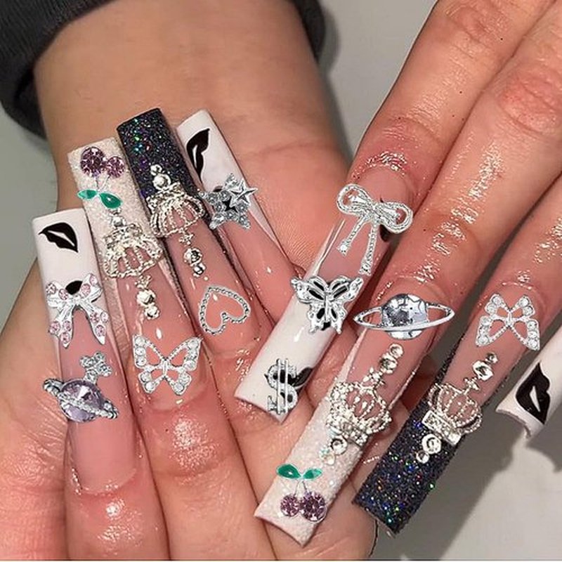 120 Pcs Silver Gold Nail Charms 3D Butterfly Cherry Star Bow Cross Planet Crown Heart Dollar Nail Gems Shiny Nail Rhinestones for Women Nail Art DIY Design（21 Styles
