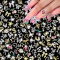 120 Pcs Silver Gold Nail Charms 3D Butterfly Cherry Star Bow Cross Planet Crown Heart Dollar Nail Gems Shiny Nail Rhinestones for Women Nail Art DIY Design（21 Styles